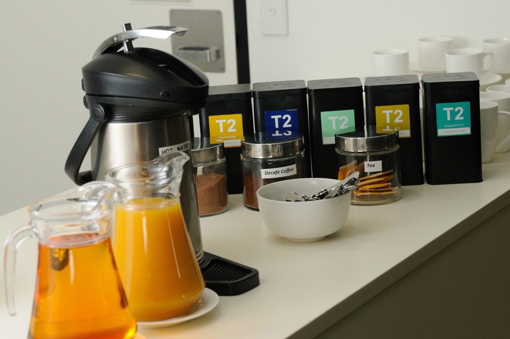 Catering table with tea, coffee and juice.