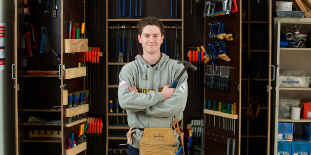 SWTAFE student in front of a tool cupboard